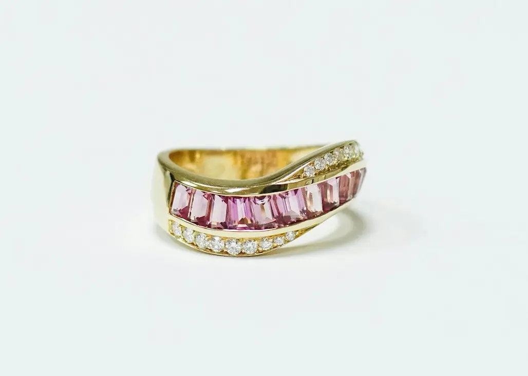 gold and black ring on white surface